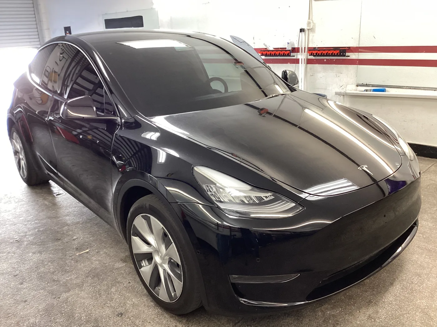White Tesla with tinted windows outside Superior’s Ontario shop